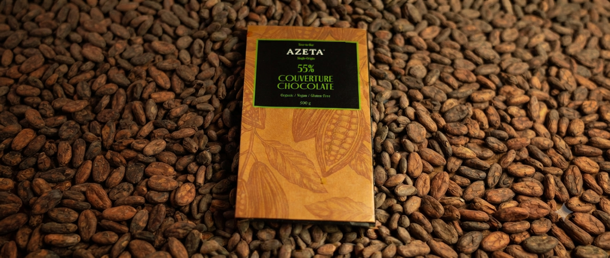 Azeta couverture chocolate bar on a bed of cacao beans
